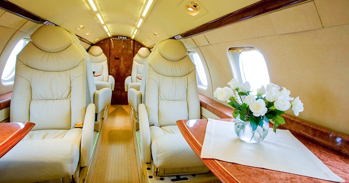Empty-leg private jet repositioning at sunset